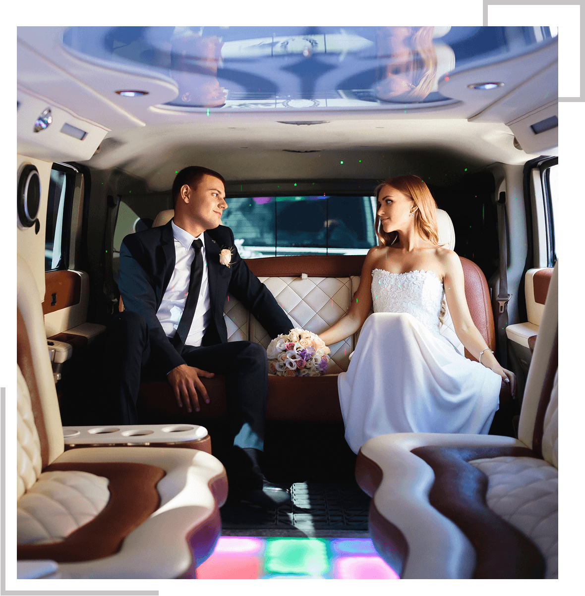 Bride and groom sitting in a limousine.