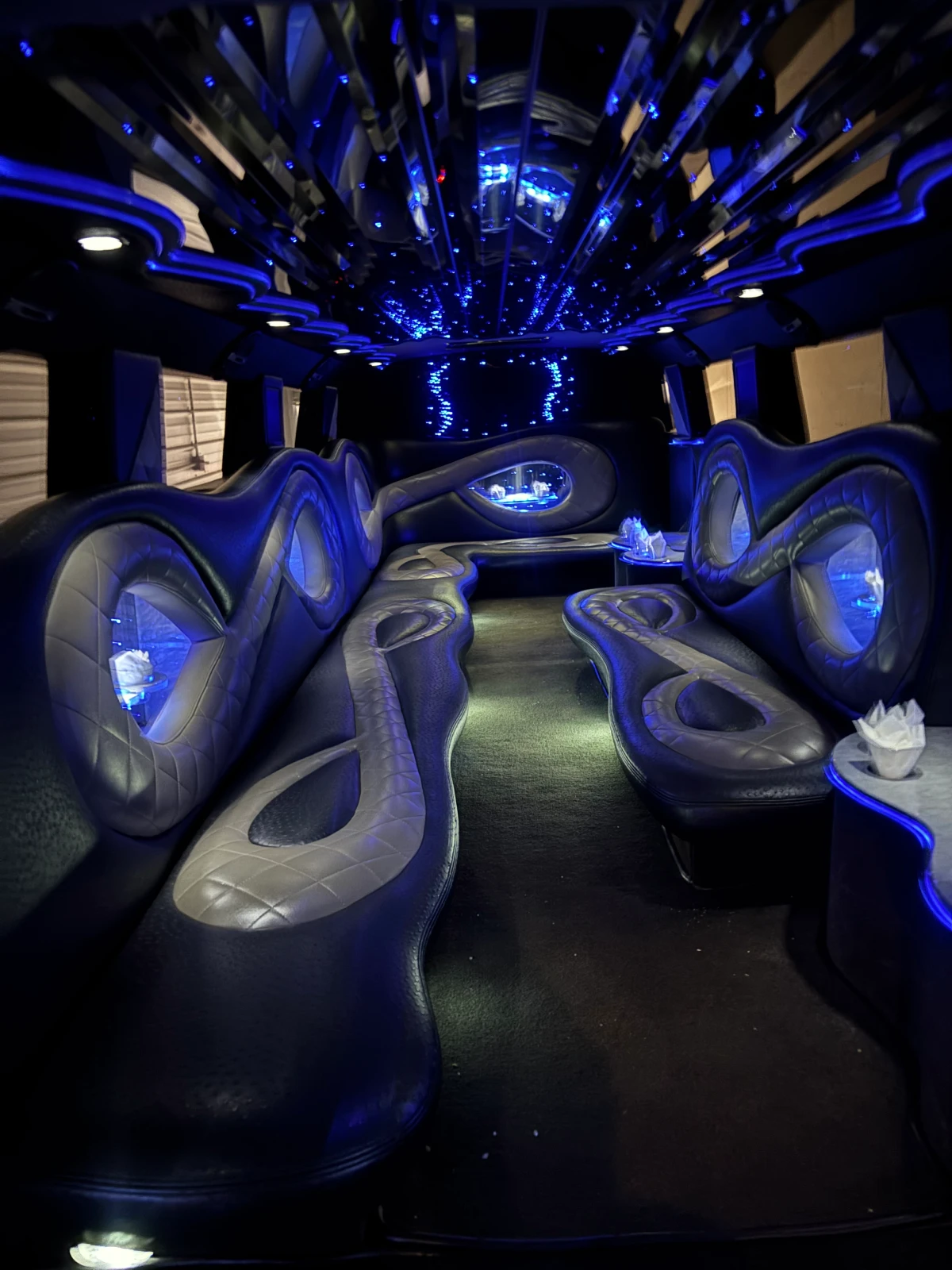 Futuristic lounge with blue lighting and sleek, curvy seating.